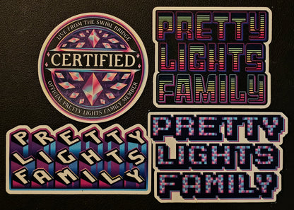 Four 'Pretty Lights Family' branded stickers on a black background