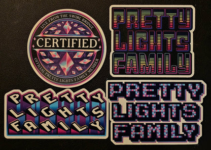 Four 'Pretty Lights Family' branded stickers on a black background